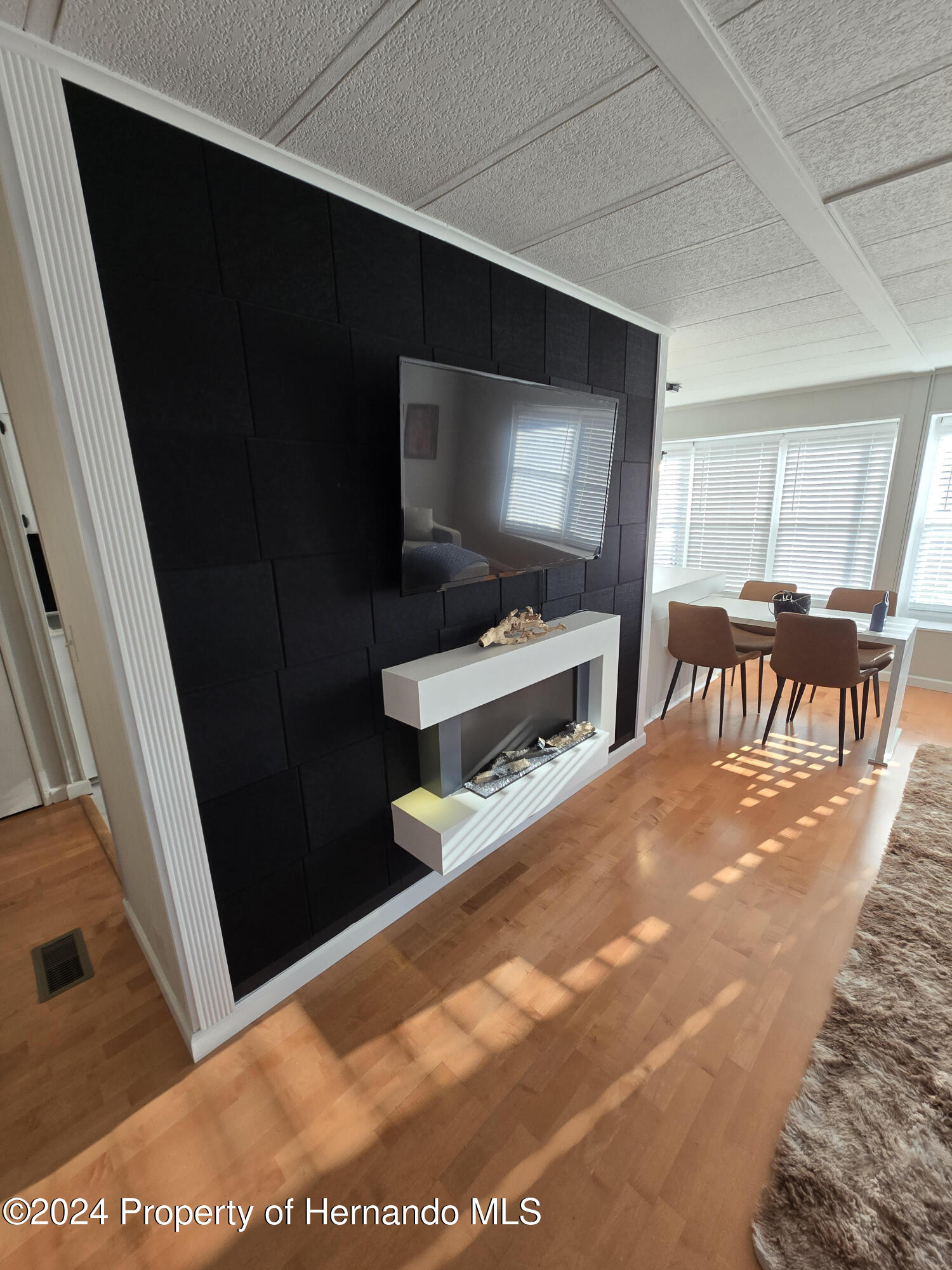 15260 Brookridge Boulevard Brooksville, FL 34613 - Photo 21 of 56 a living room with furniture and a flat screen tv