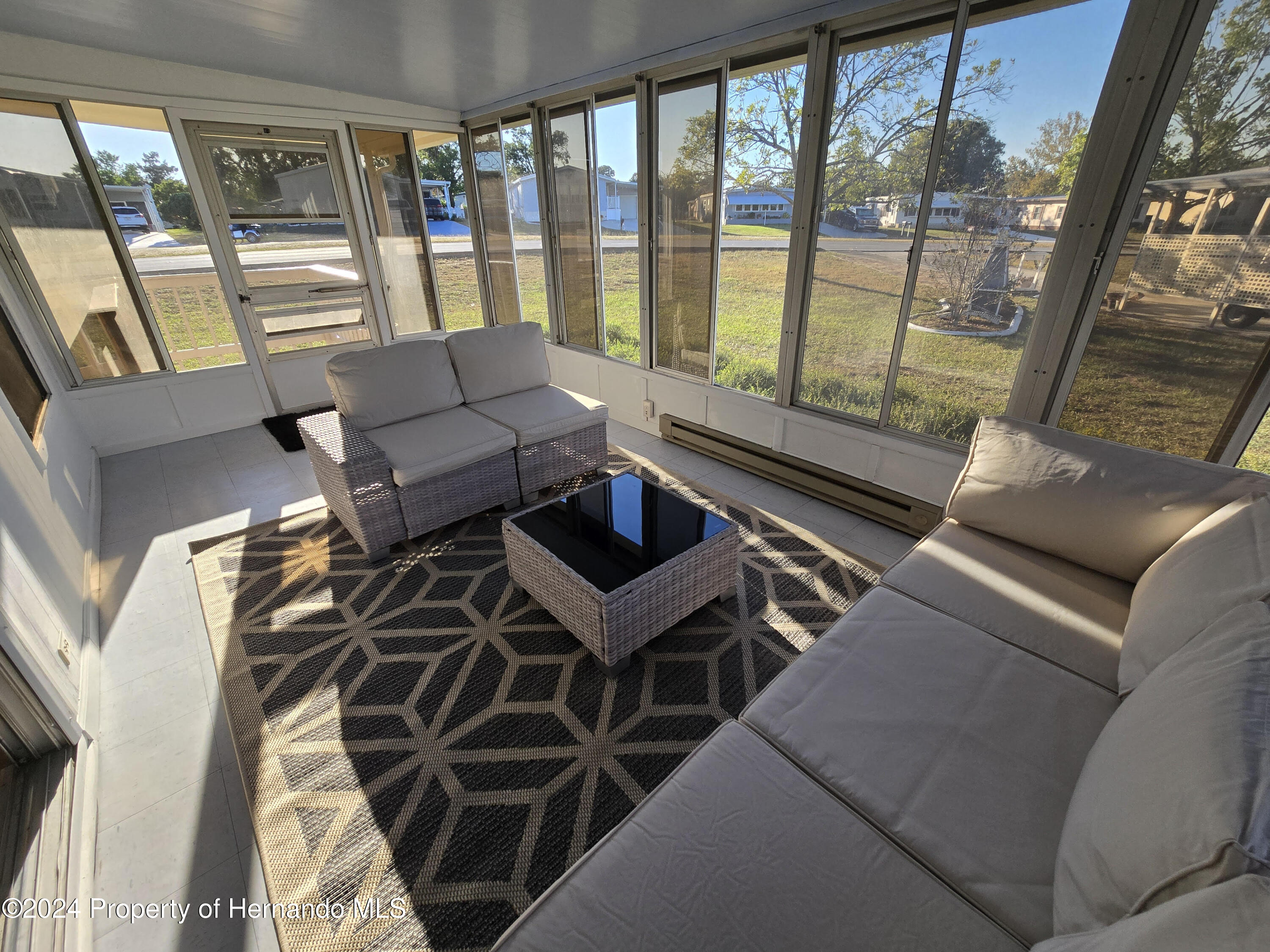15260 Brookridge Boulevard Brooksville, FL 34613 - Photo 25 of 56 a living room with furniture and a floor to ceiling window