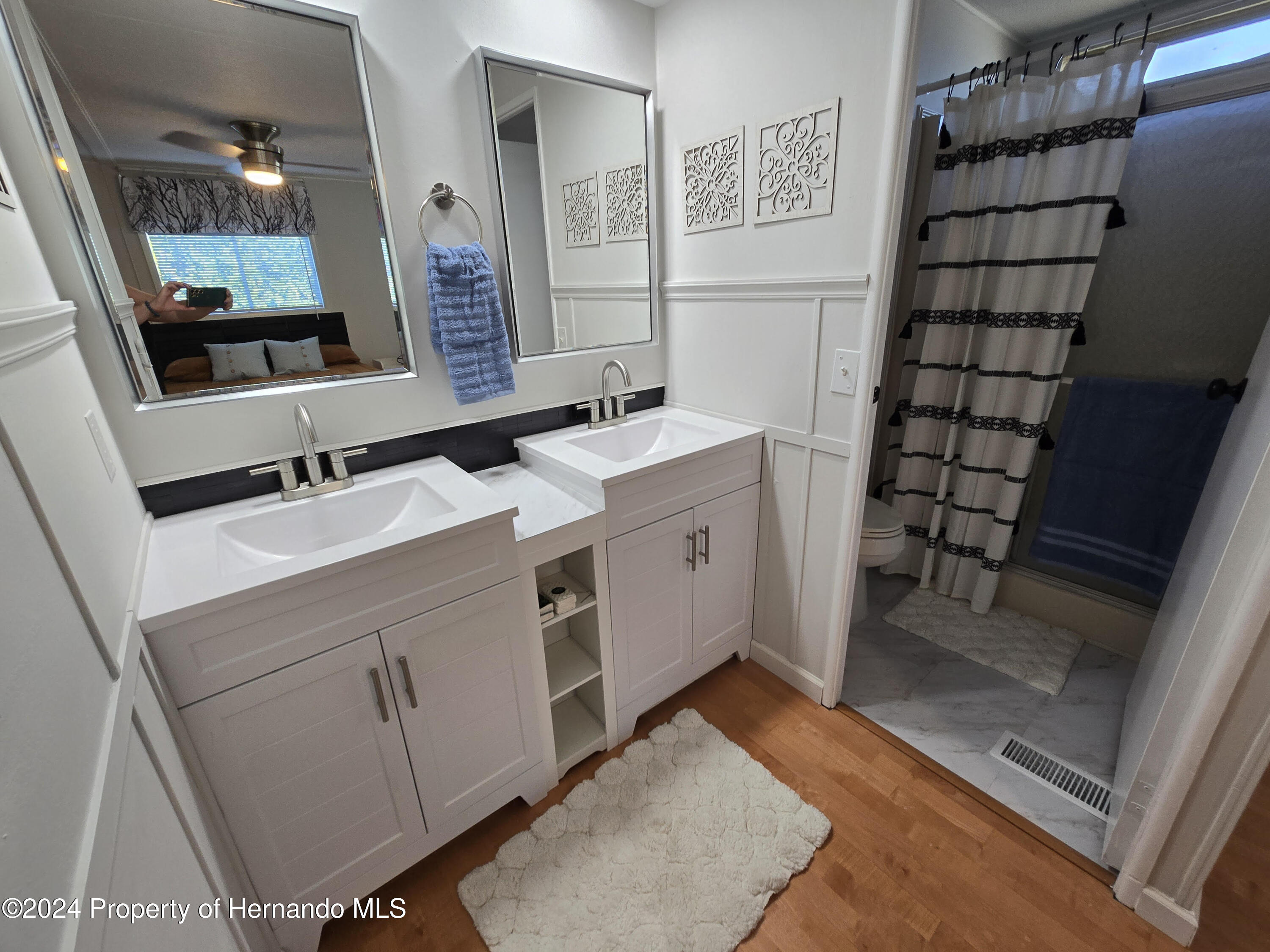 15260 Brookridge Boulevard Brooksville, FL 34613 - Photo 39 of 56 a bathroom with a sink and a mirror