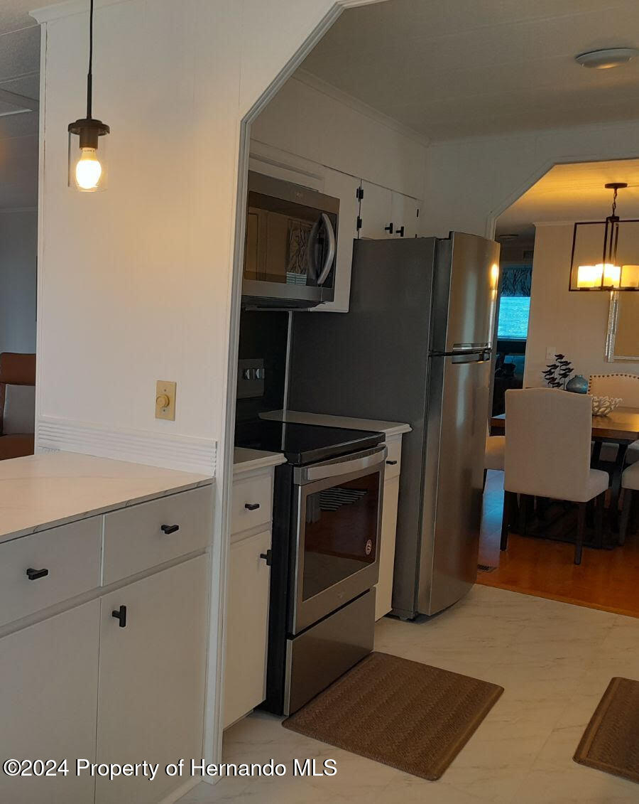 15260 Brookridge Boulevard Brooksville, FL 34613 - Photo 4 of 56 a kitchen with a refrigerator and a stove