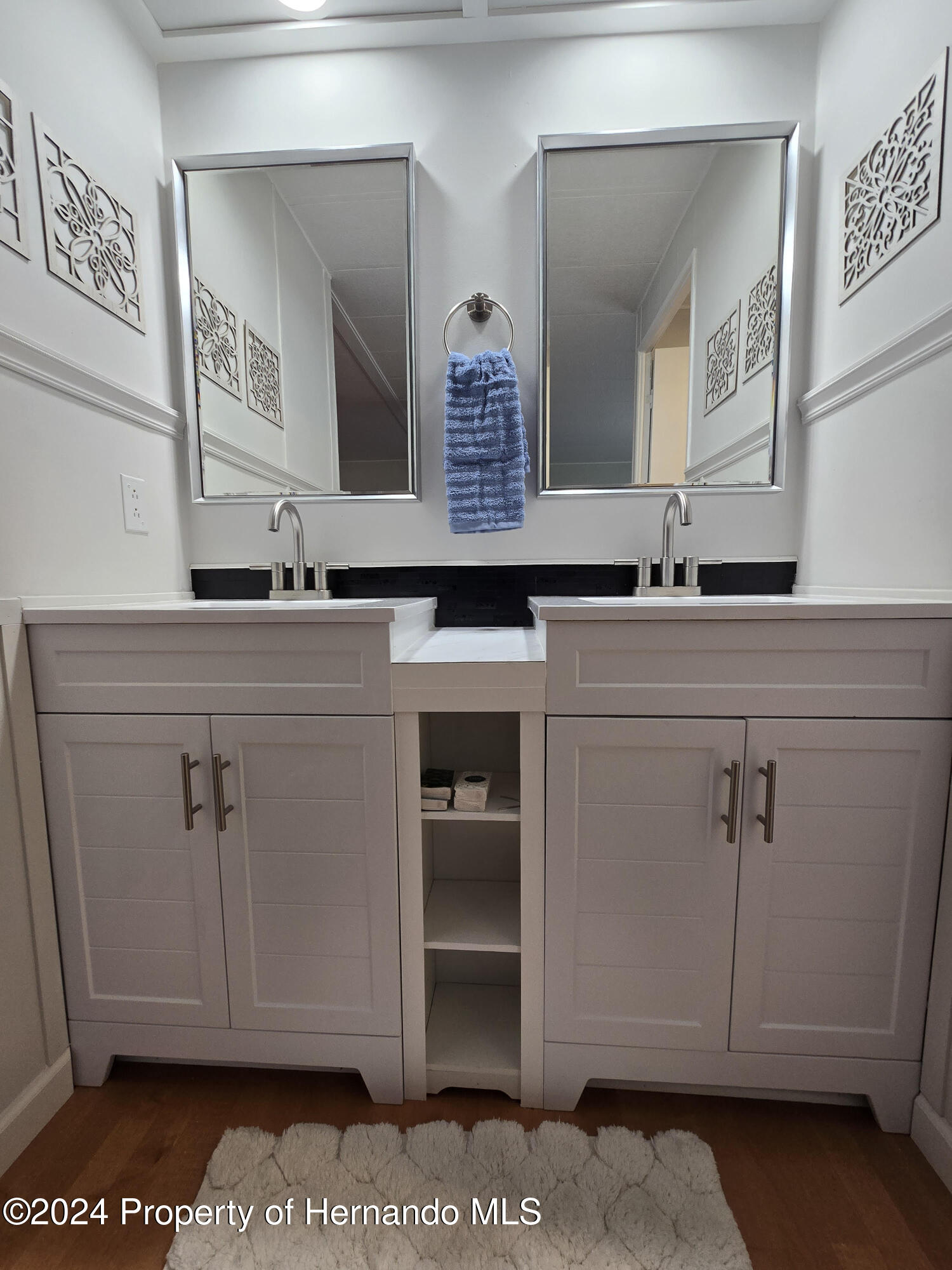 15260 Brookridge Boulevard Brooksville, FL 34613 - Photo 45 of 56 a bathroom with a sink and a mirror