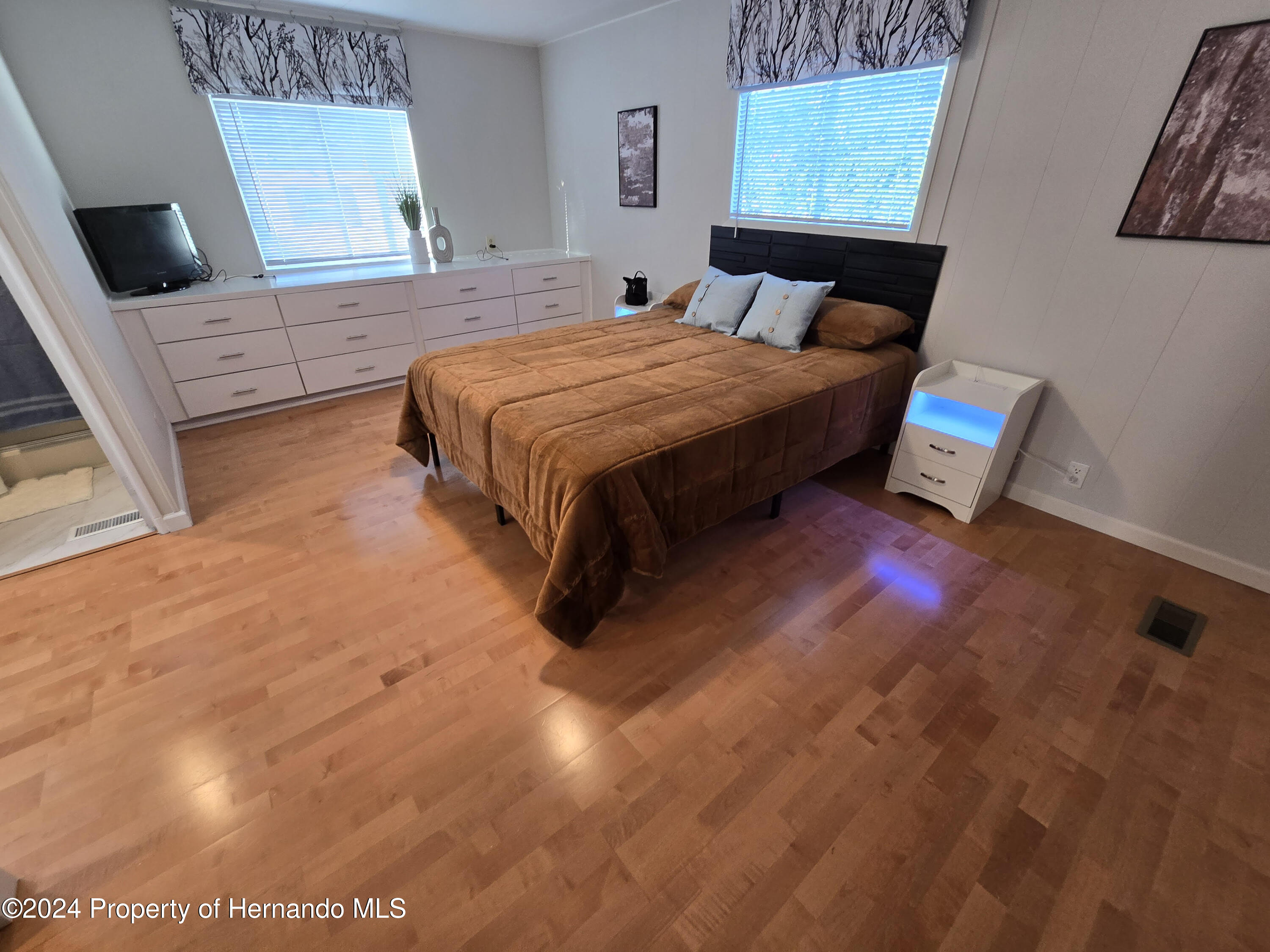 15260 Brookridge Boulevard Brooksville, FL 34613 - Photo 46 of 56 a bedroom with a bed and flat screen tv