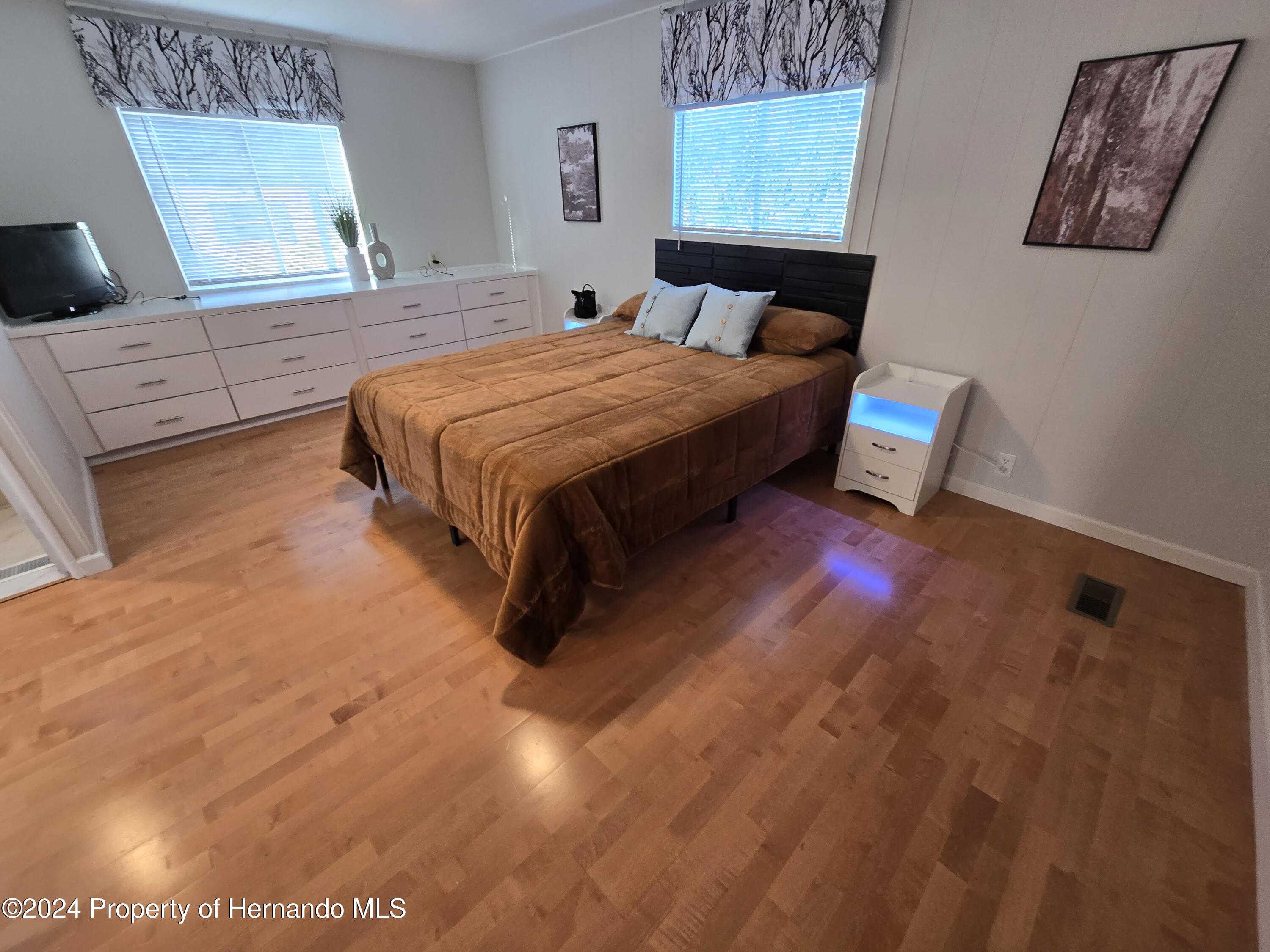 15260 Brookridge Boulevard Brooksville, FL 34613 - Photo 48 of 56 a bedroom with a bed and a flat tv screen on the dresser