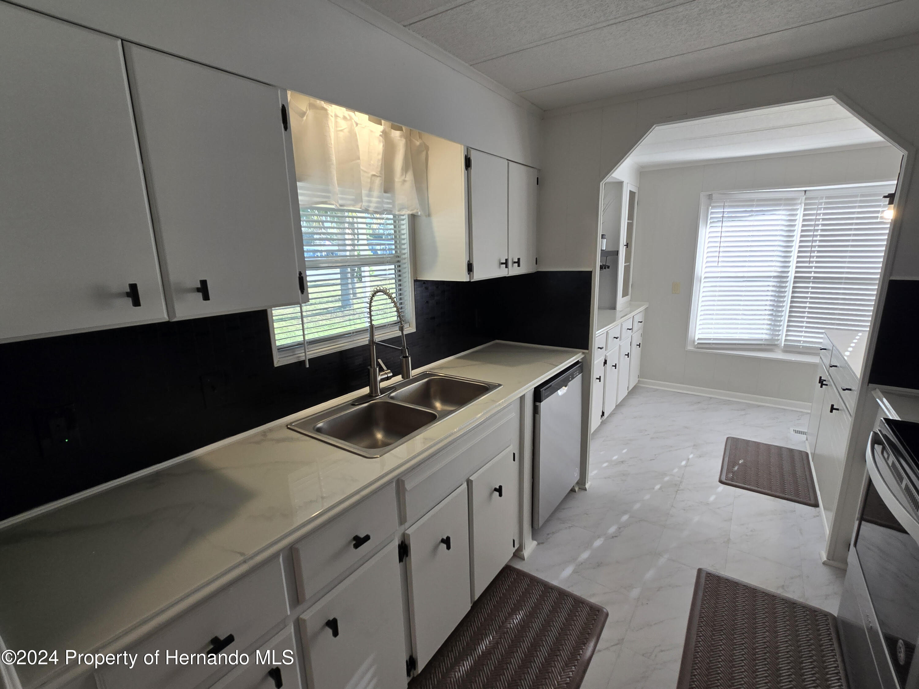 15260 Brookridge Boulevard Brooksville, FL 34613 - Photo 5 of 56 a kitchen with a cabinets and white appliances