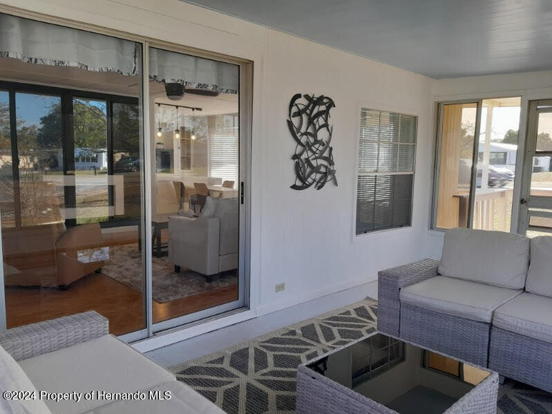 15260 Brookridge Boulevard Brooksville, FL 34613 - Photo 56 of 56 a living room with furniture and a floor to ceiling window