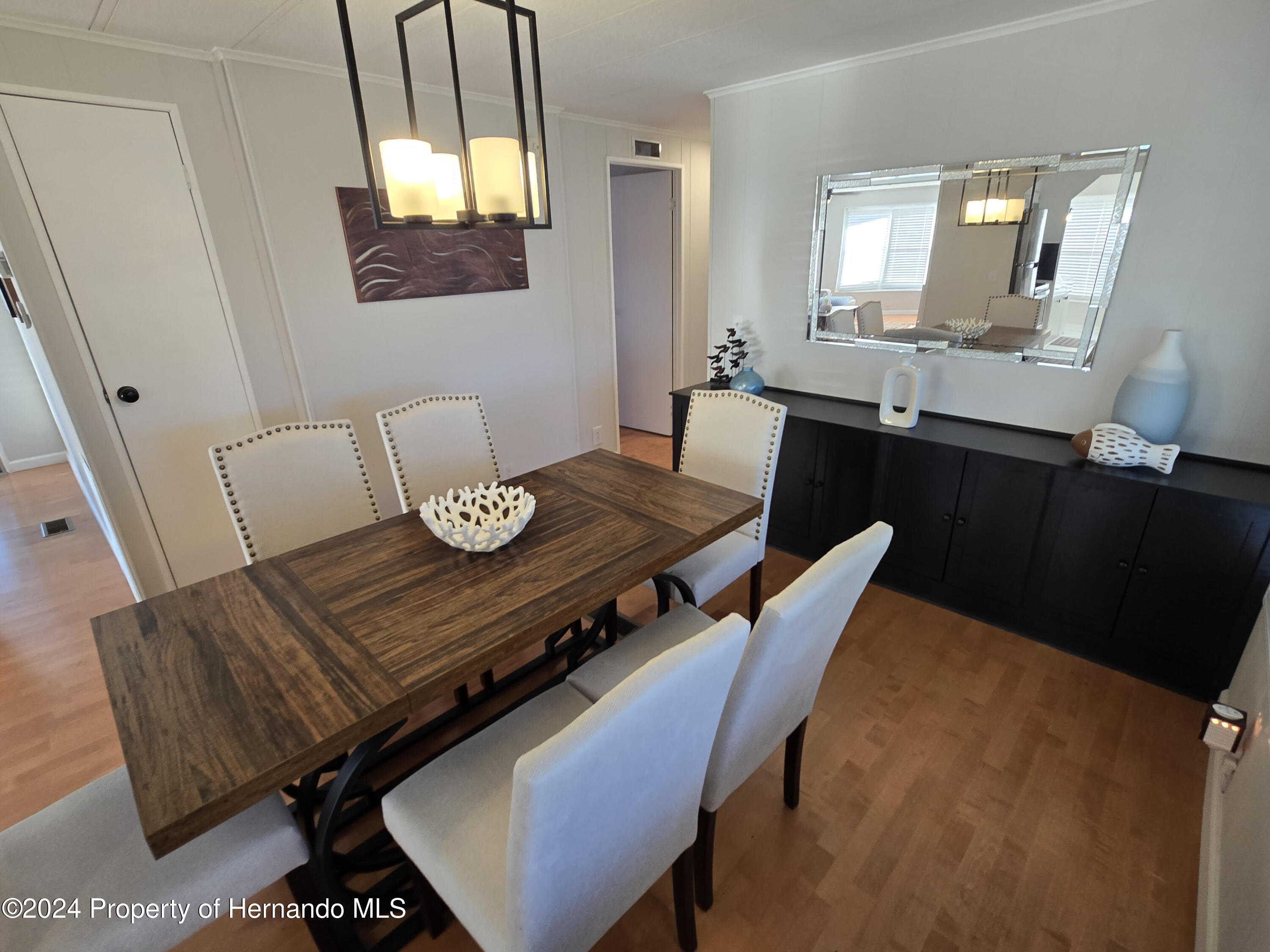 15260 Brookridge Boulevard Brooksville, FL 34613 - Photo 6 of 56 a view of a dining room with furniture and wooden floor