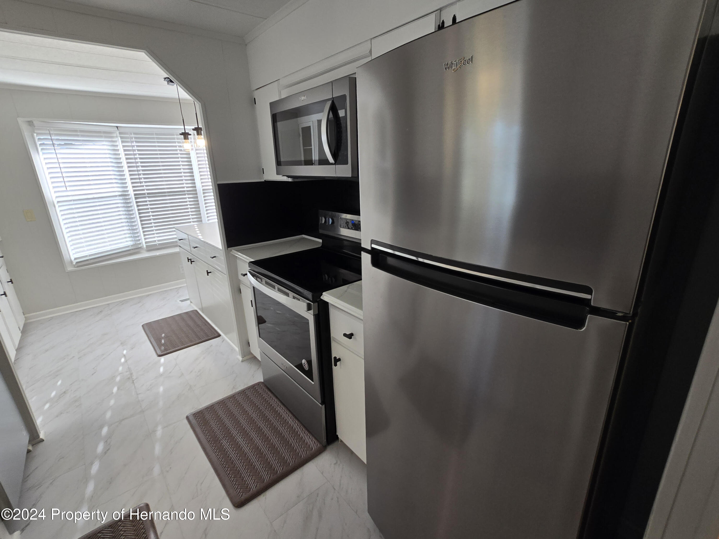 15260 Brookridge Boulevard Brooksville, FL 34613 - Photo 10 of 56 a view of kitchen and utility room