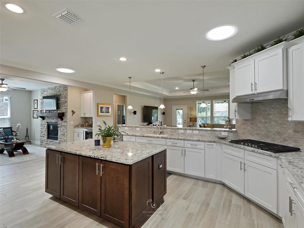 a kitchen with counter top space sink and center island
