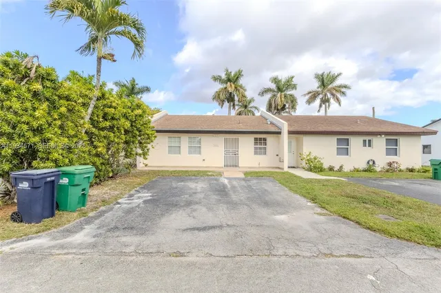 a front view of a house with a garden and entryway
