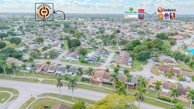 an aerial view of a house with garden space and street view