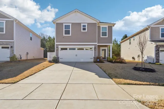 a front view of a house with garage