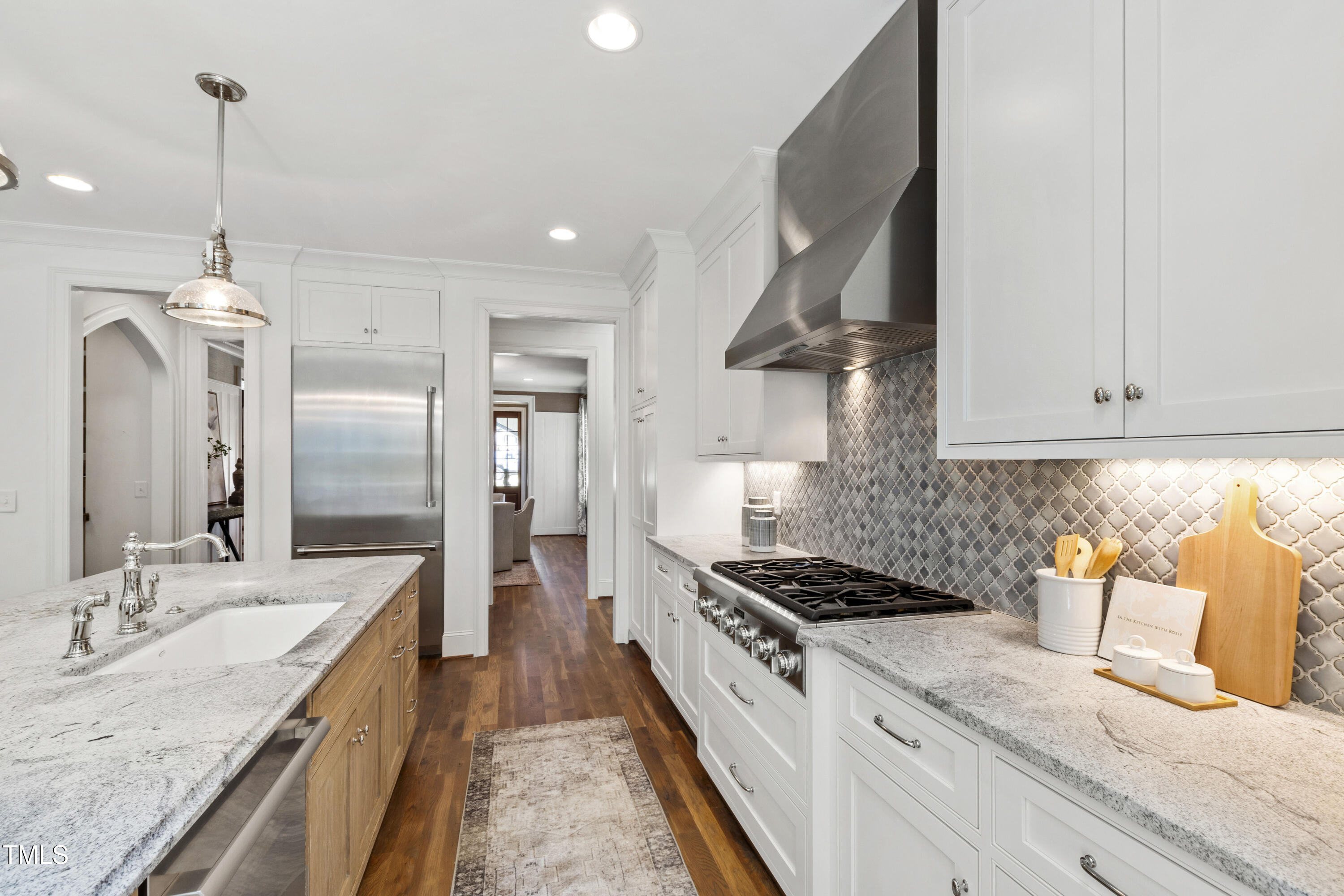 523 Vick Avenue Raleigh, NC 27612 - Photo 18 of 77 a kitchen with stainless steel appliances granite countertop a sink stove and refrigerator