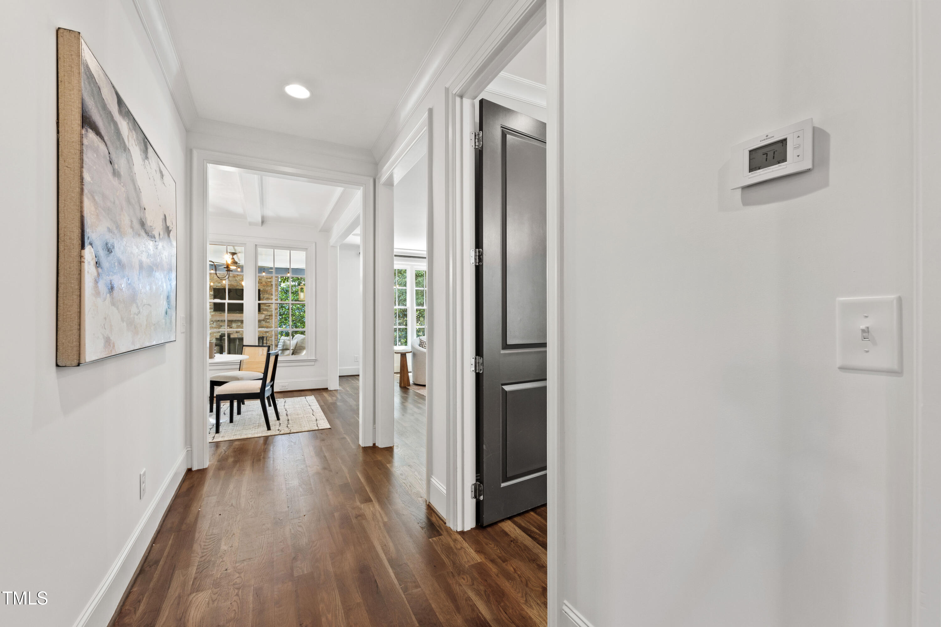 523 Vick Avenue Raleigh, NC 27612 - Photo 26 of 77 a view of a hallway with wooden floor and a living room