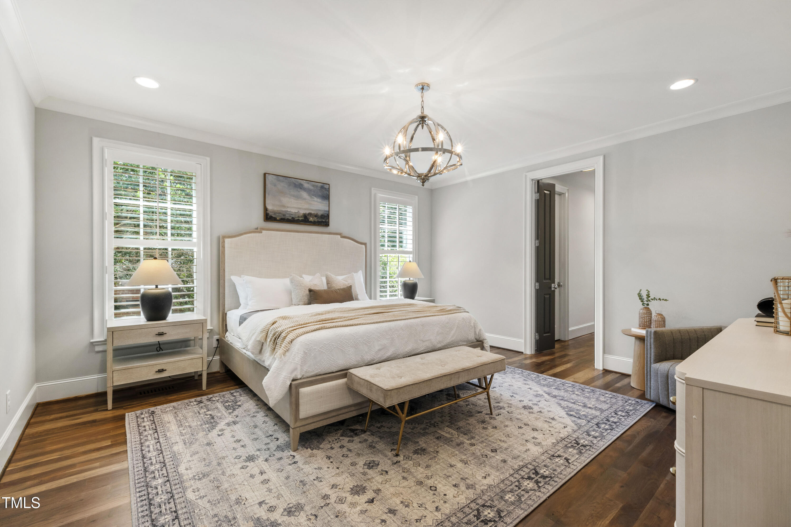 523 Vick Avenue Raleigh, NC 27612 - Photo 27 of 77 a bedroom with a bed and a chandelier