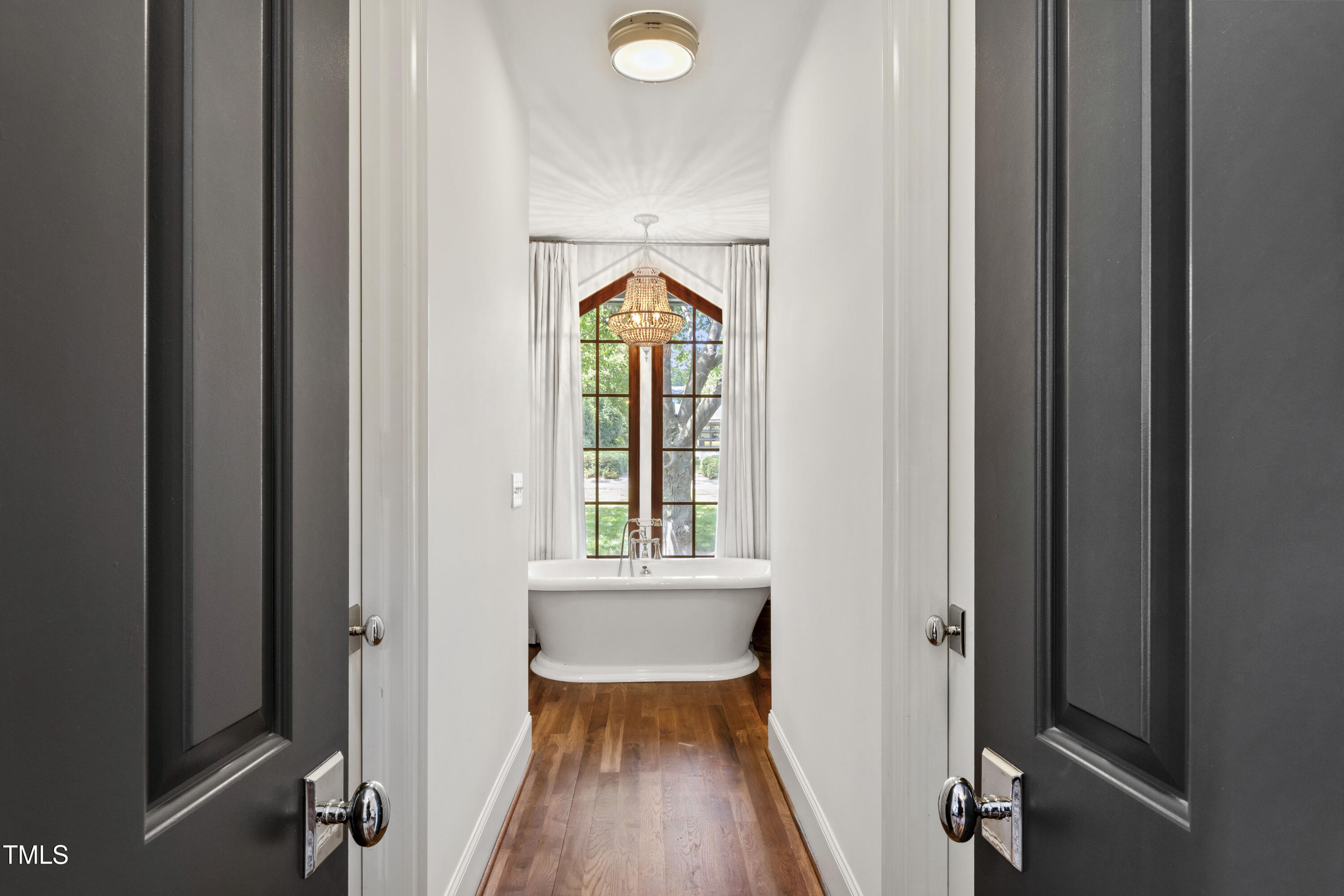 523 Vick Avenue Raleigh, NC 27612 - Photo 29 of 77 a view of a hallway with wooden floor and a bathroom