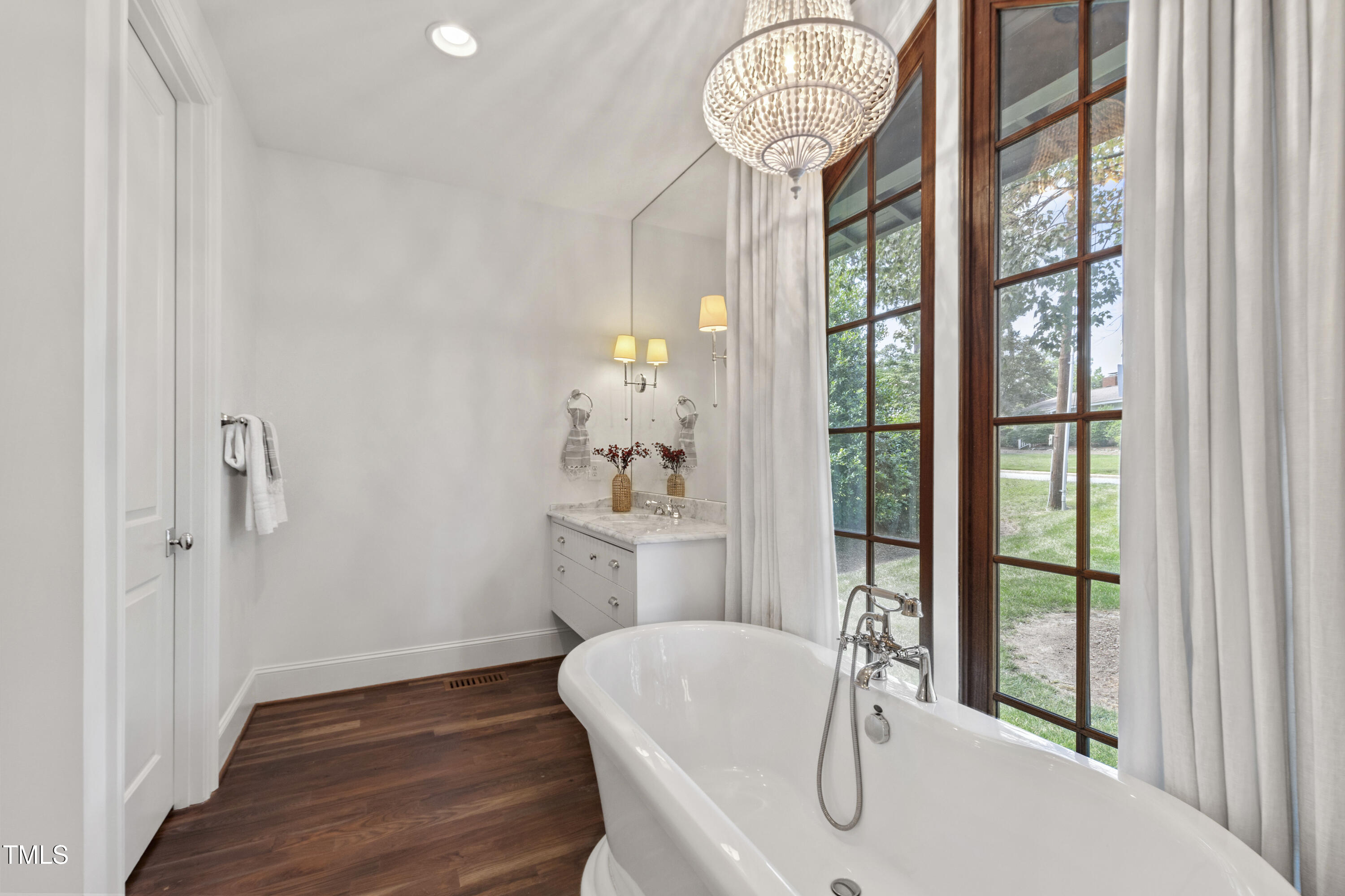 523 Vick Avenue Raleigh, NC 27612 - Photo 31 of 77 a dining room with furniture a chandelier and wooden floor