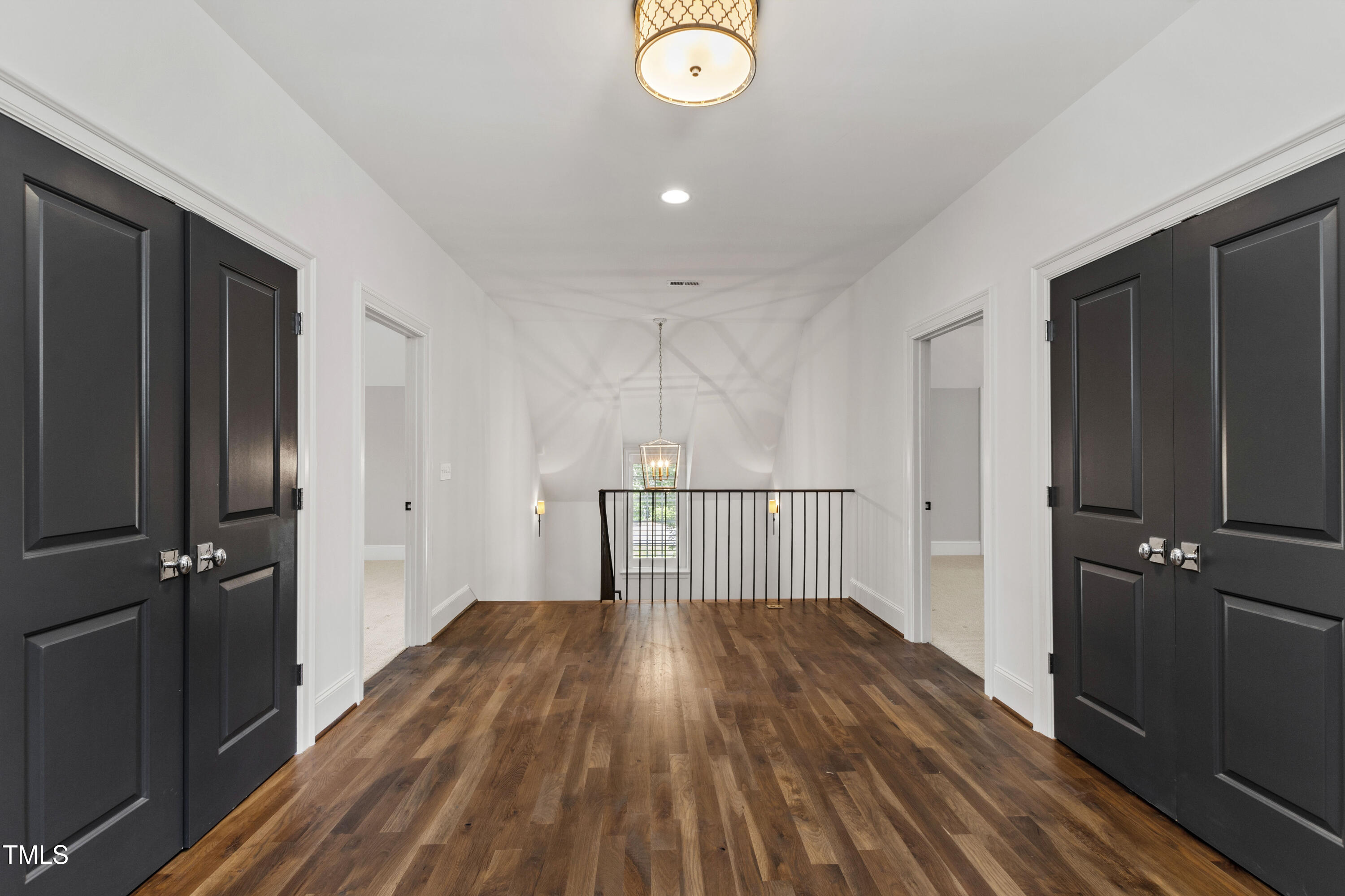 523 Vick Avenue Raleigh, NC 27612 - Photo 38 of 77 a view of a hallway with wooden floor and a bathroom