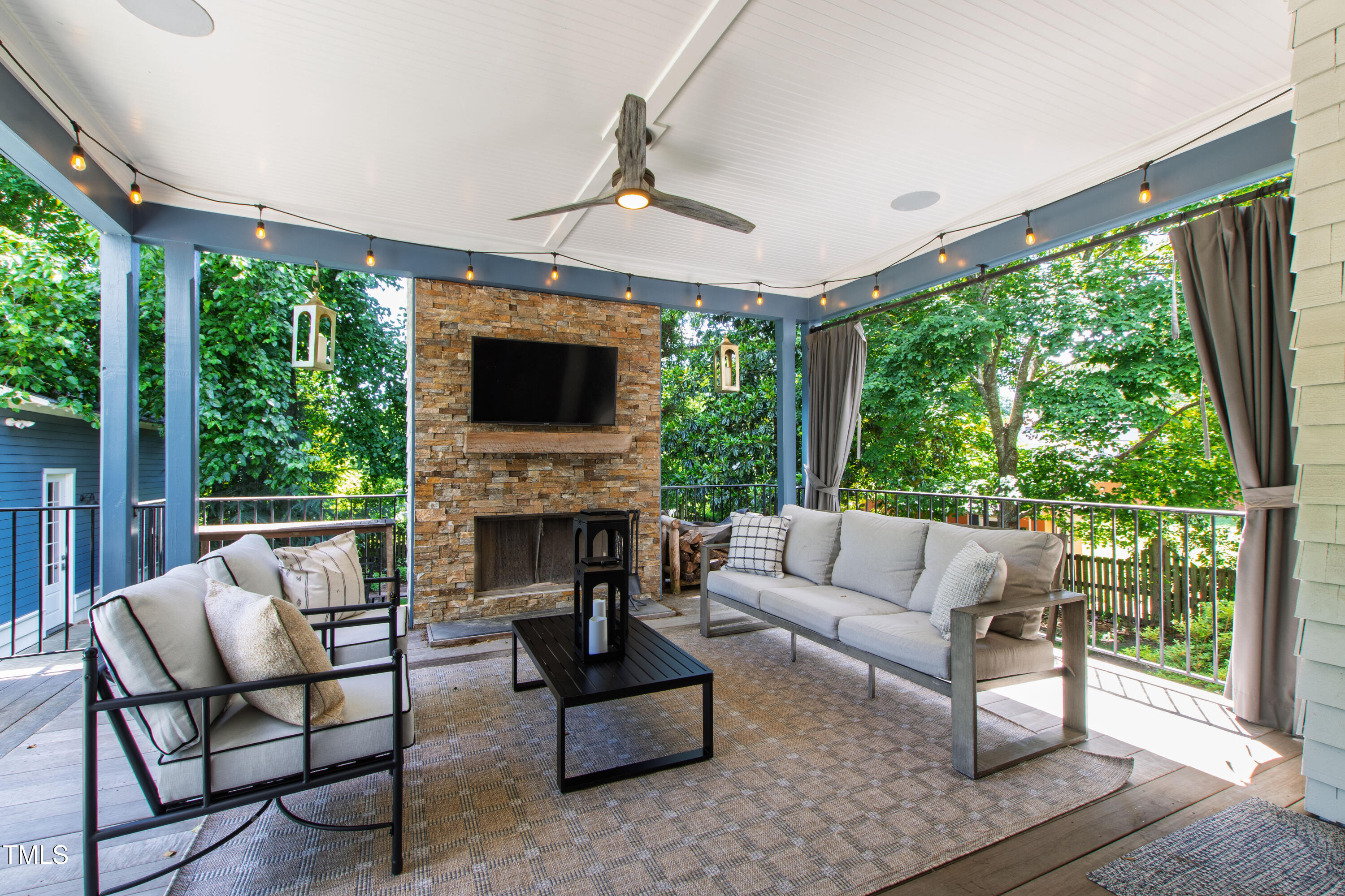 523 Vick Avenue Raleigh, NC 27612 - Photo 56 of 77 a living room with furniture a flat screen tv and a fireplace