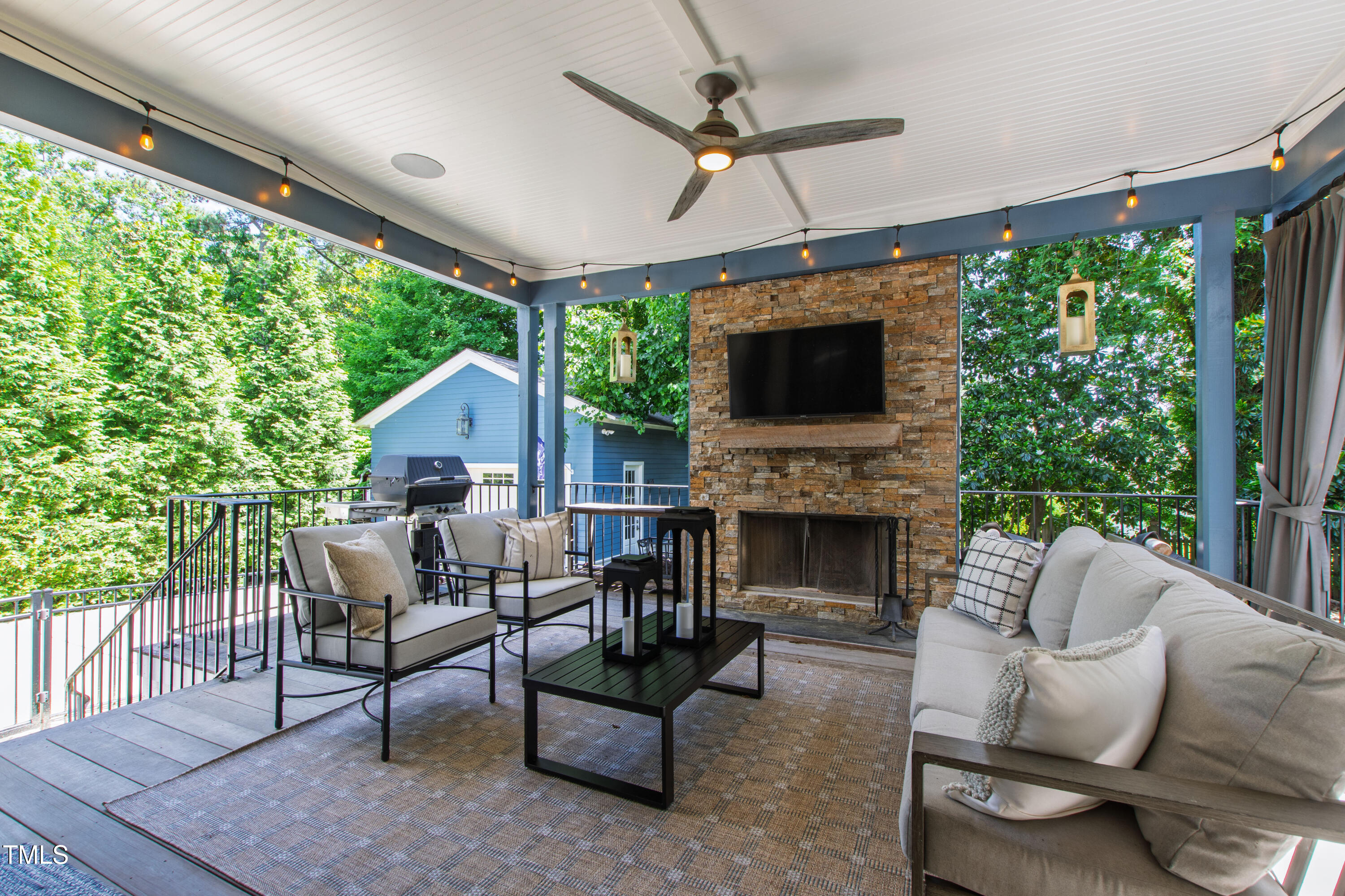 523 Vick Avenue Raleigh, NC 27612 - Photo 57 of 77 a living room with furniture a fireplace and a flat screen tv