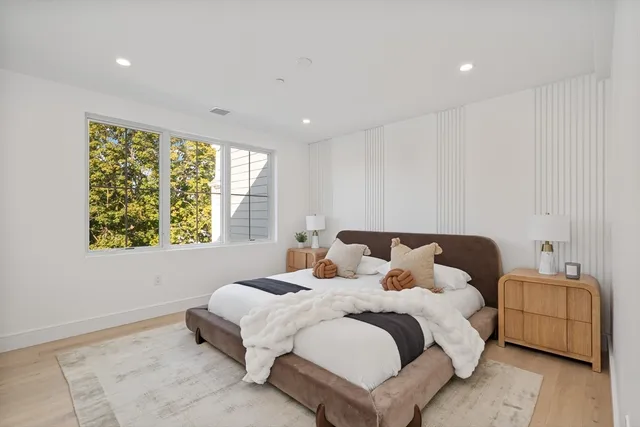 a bedroom with a bed and a window