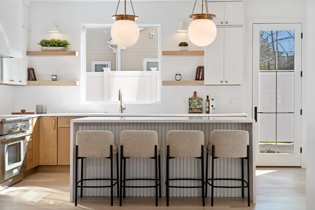 a kitchen with a table chairs sink and stove