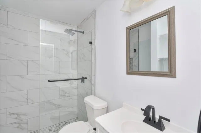 a bathroom with a toilet sink and shower