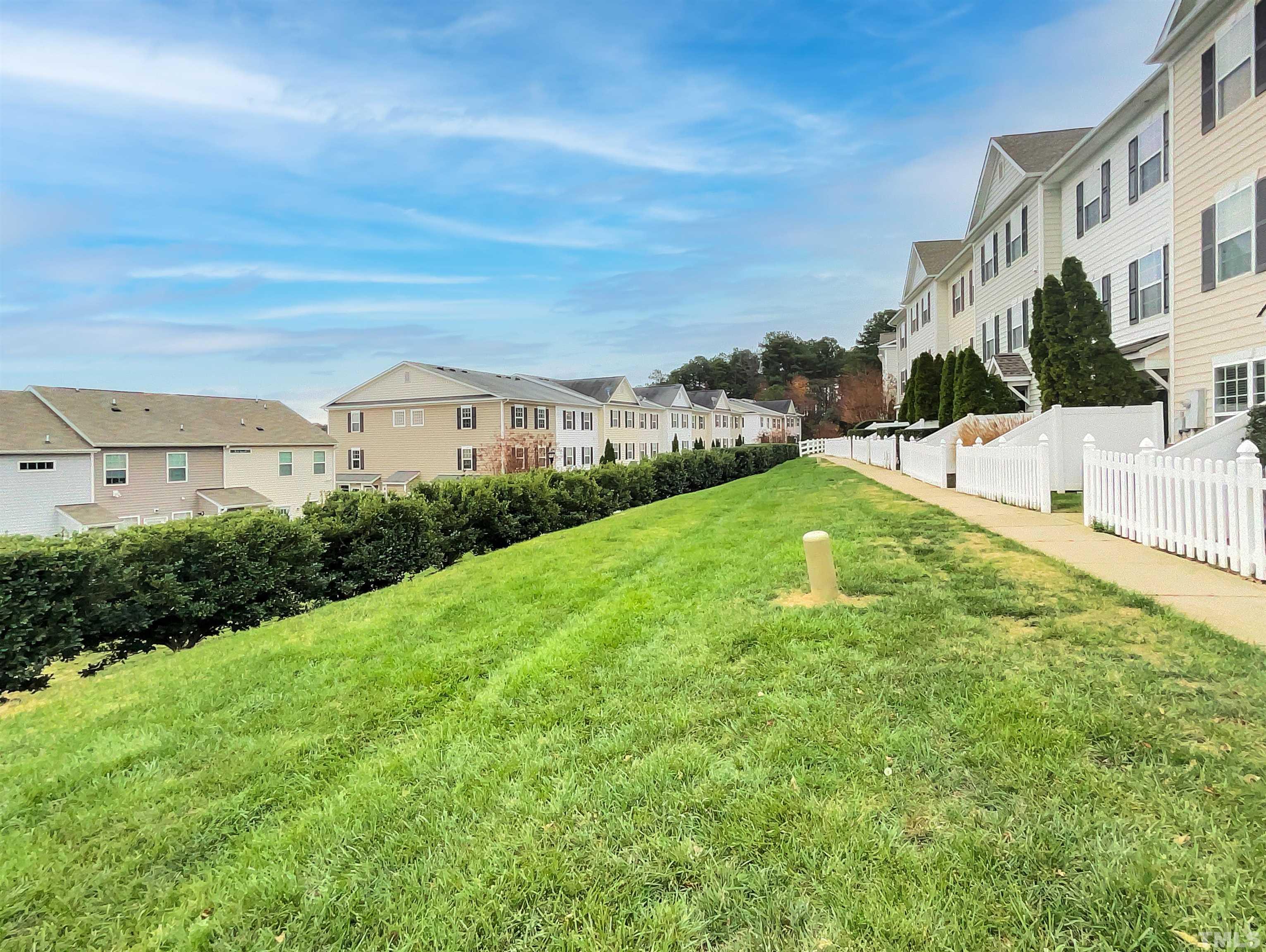 1111 Consortium Drive, Unit 101 Raleigh, NC 27603 - Photo 17 of 17 a view of a house with a yard