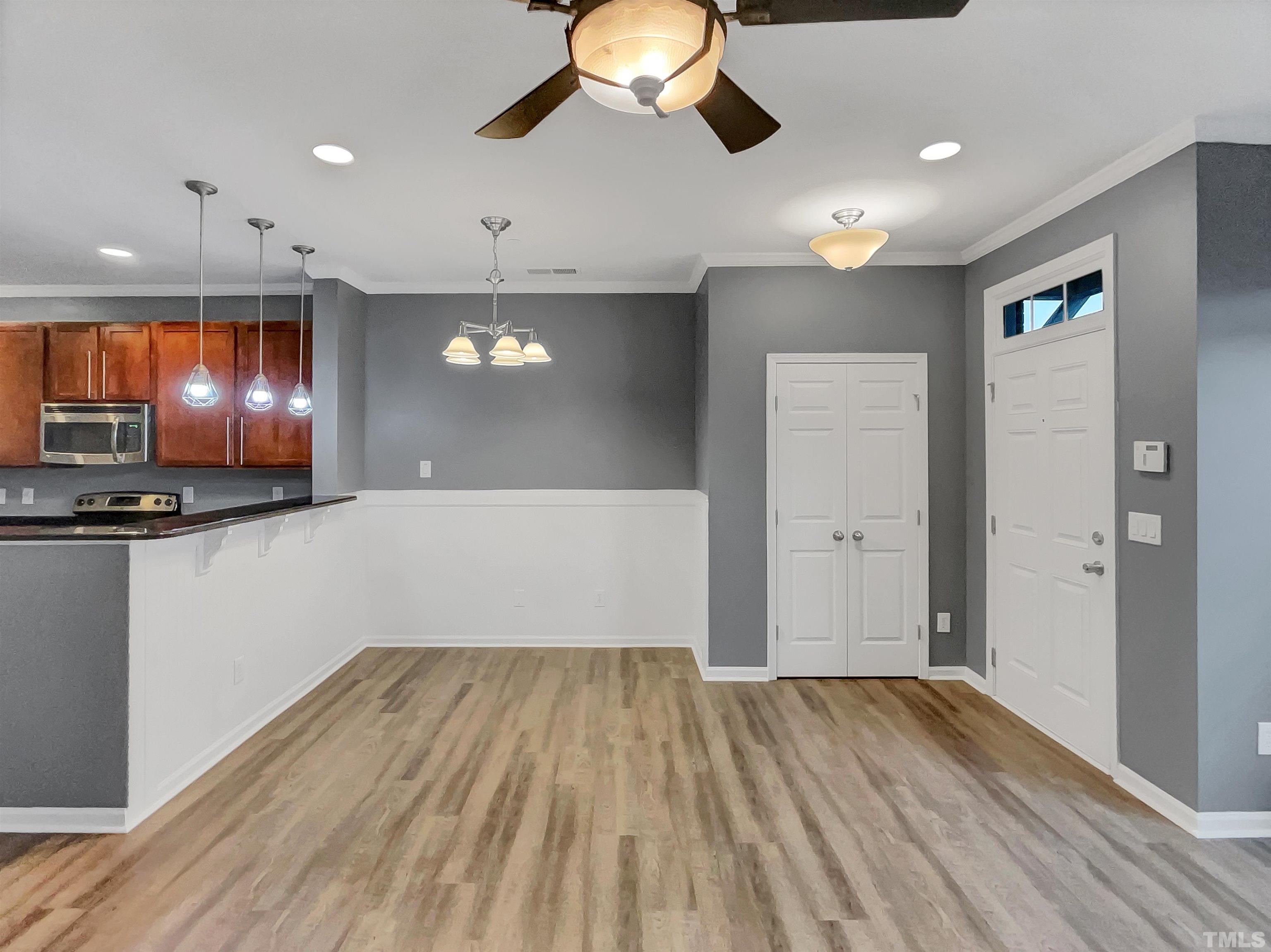 1111 Consortium Drive, Unit 101 Raleigh, NC 27603 - Photo 4 of 17 a view of empty room with wooden floor