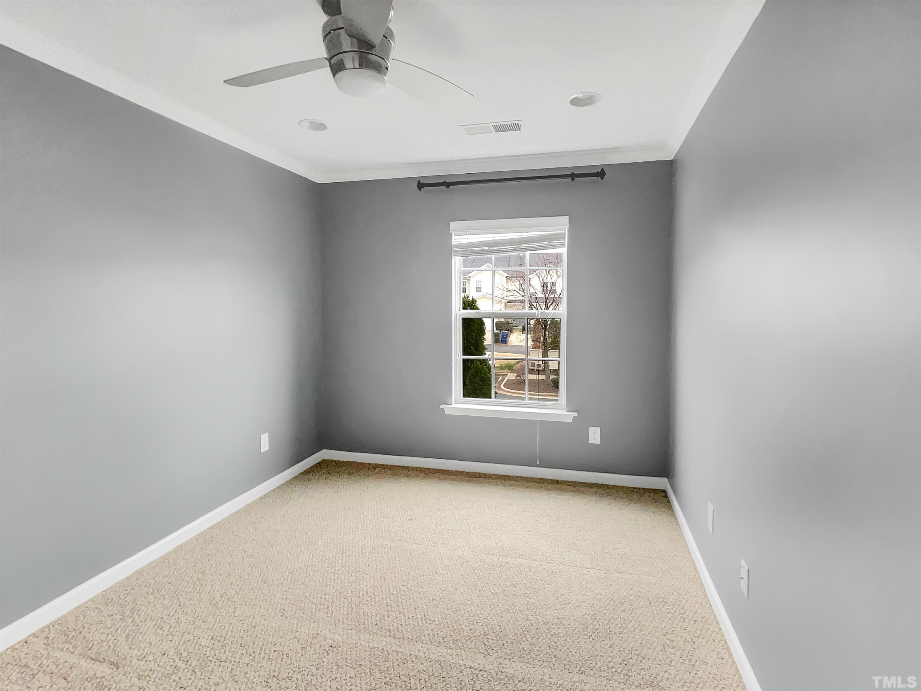 1111 Consortium Drive, Unit 101 Raleigh, NC 27603 - Photo 10 of 17 an empty room with windows
