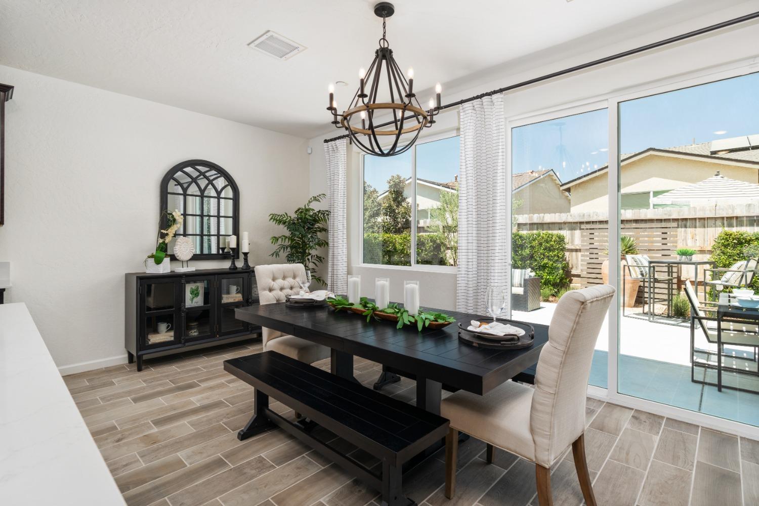 1198 Significant Way West Madera, CA 93636 - Photo 14 of 29 a dining room with furniture a chandelier and wooden floor
