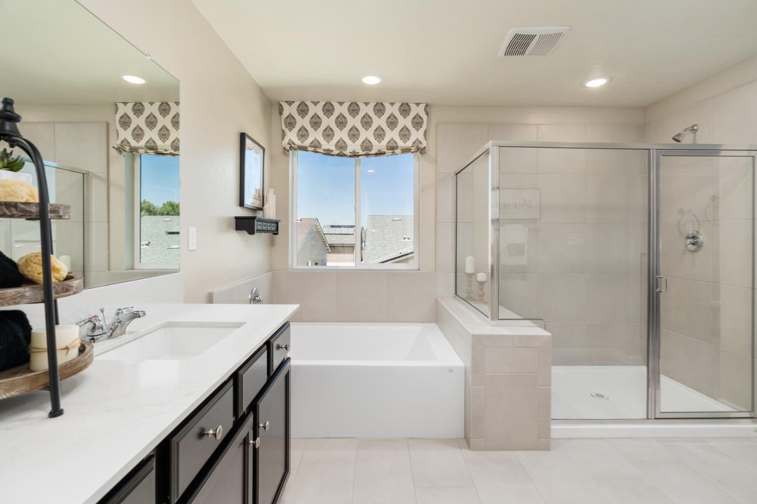 1198 Significant Way West Madera, CA 93636 - Photo 20 of 29 a bathroom with a tub a sink shower and mirror