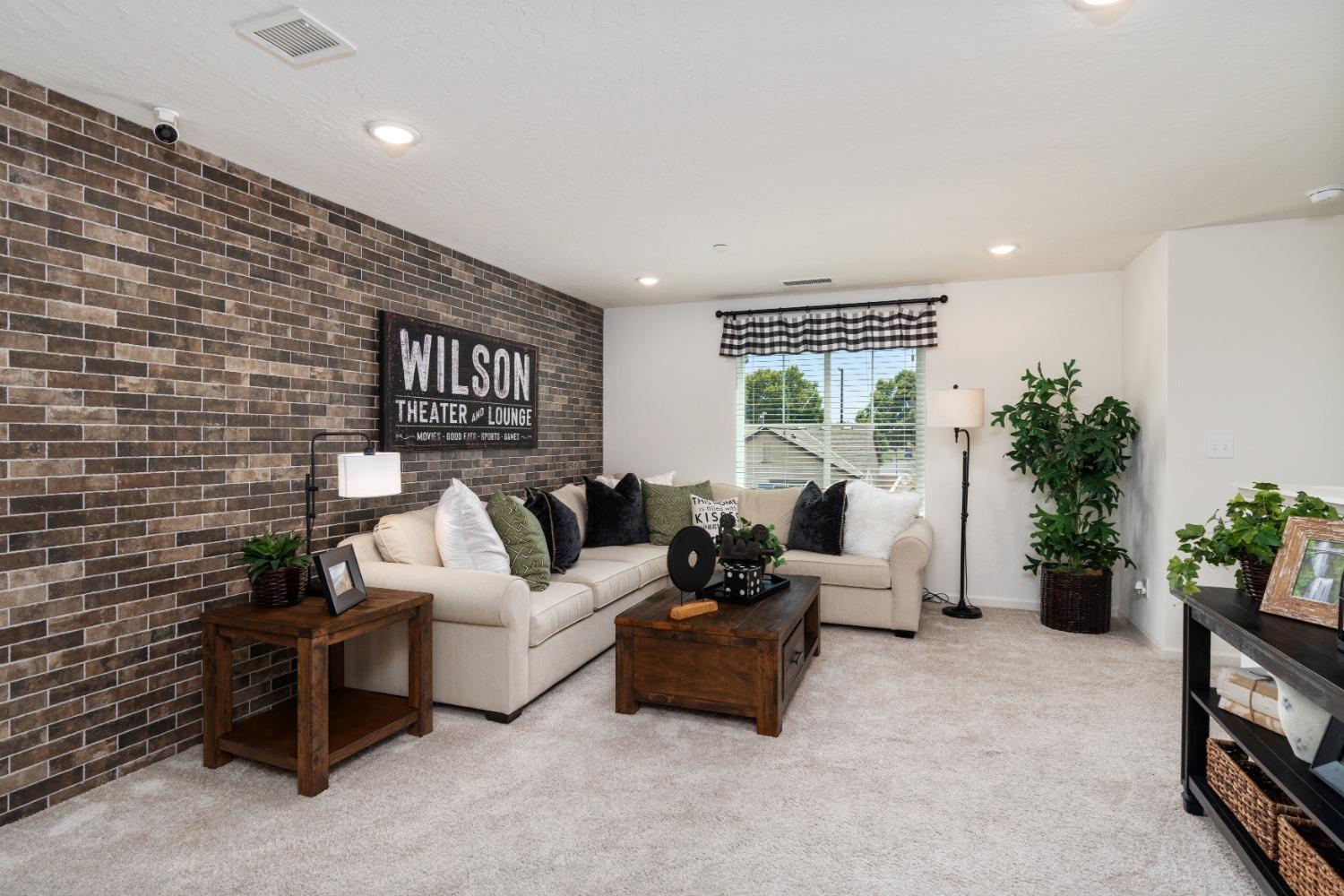 1198 Significant Way West Madera, CA 93636 - Photo 22 of 29 a living room with furniture potted plant floor to ceiling window and potted plant