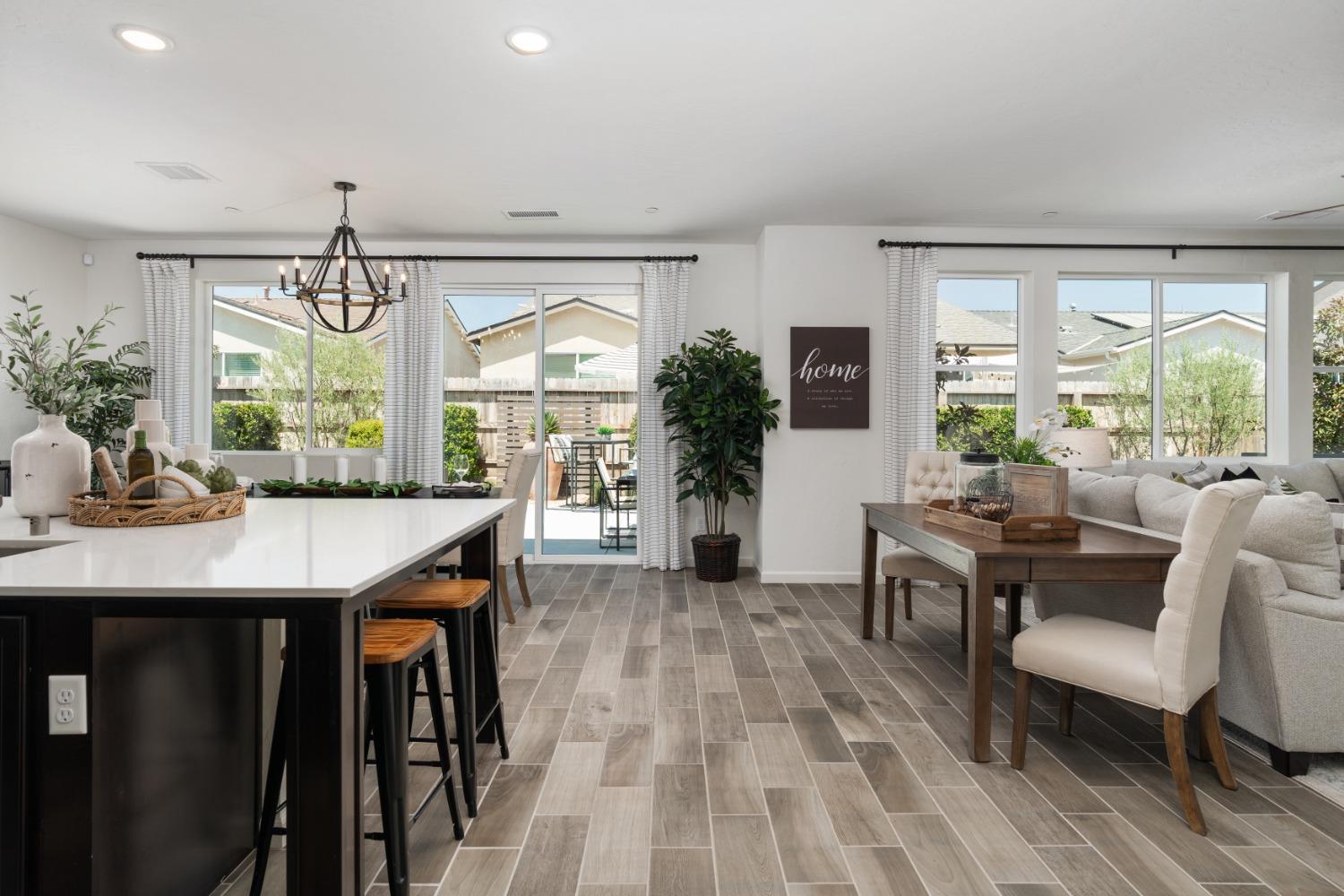 1198 Significant Way West Madera, CA 93636 - Photo 9 of 29 a living room with furniture a window and a dining table