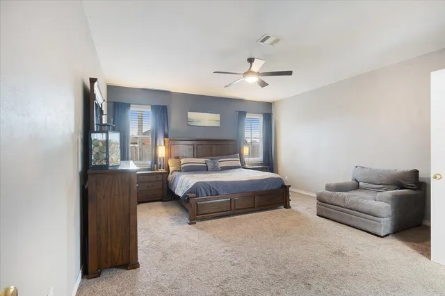 a bedroom with a bed couch and window