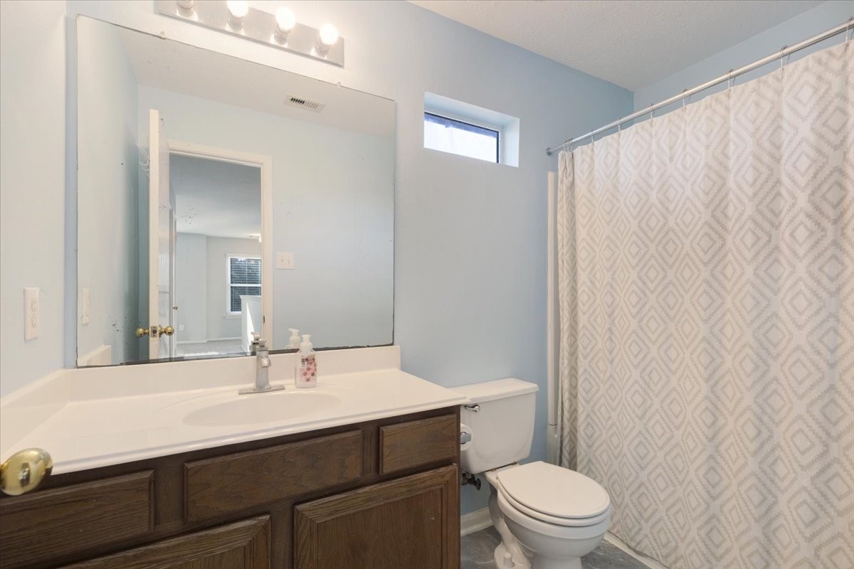 1202 Collier Point Lane Fresno, TX 77545 - Photo 21 of 29 The upstairs bathroom includes warm wooden cabinetry with ample storage, white countertops, and bathtub/shower combo perfect for everyday use.