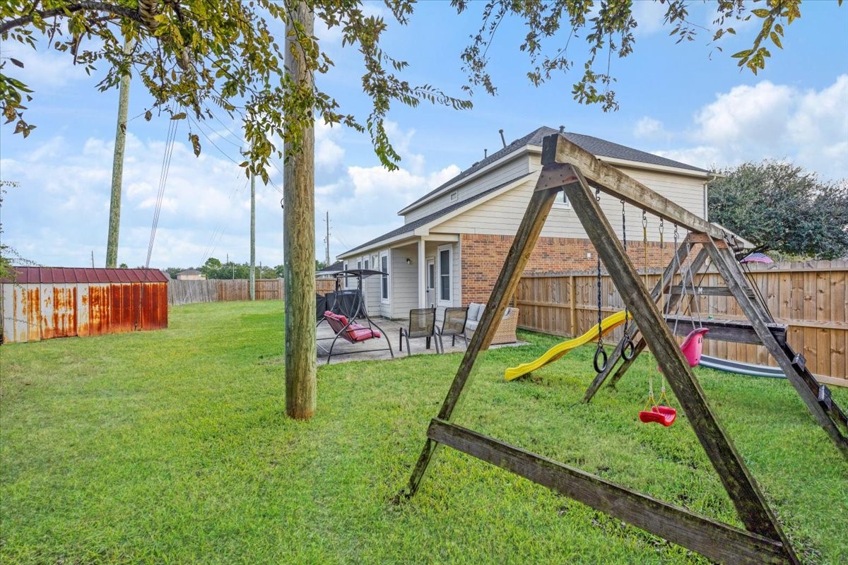 1202 Collier Point Lane Fresno, TX 77545 - Photo 24 of 29 The backyard provides ample space, a storage shed, and a patio, creating the perfect outdoor retreat.