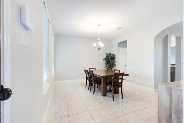 a view of a dining room with furniture and chandelier