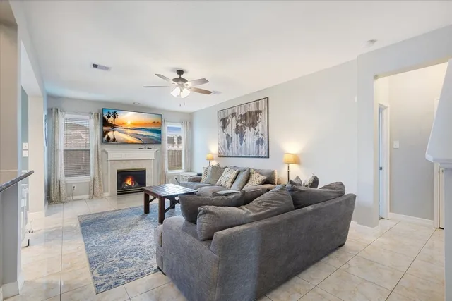 a living room with furniture a fireplace and a flat screen tv