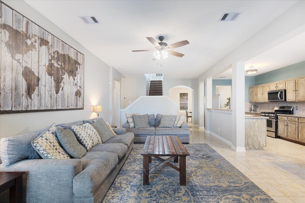 1202 Collier Point Lane Fresno, TX 77545 - Photo 7 of 29 The living room seamlessly opens to the kitchen, creating a perfect layout for entertaining guests.