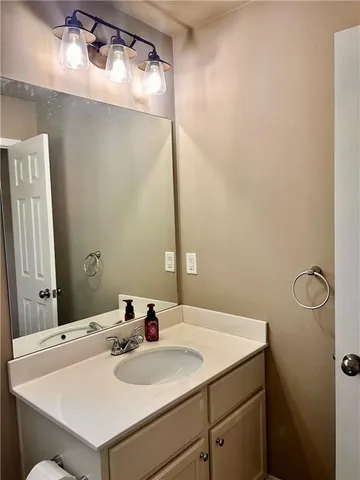 a bathroom with a sink and mirror
