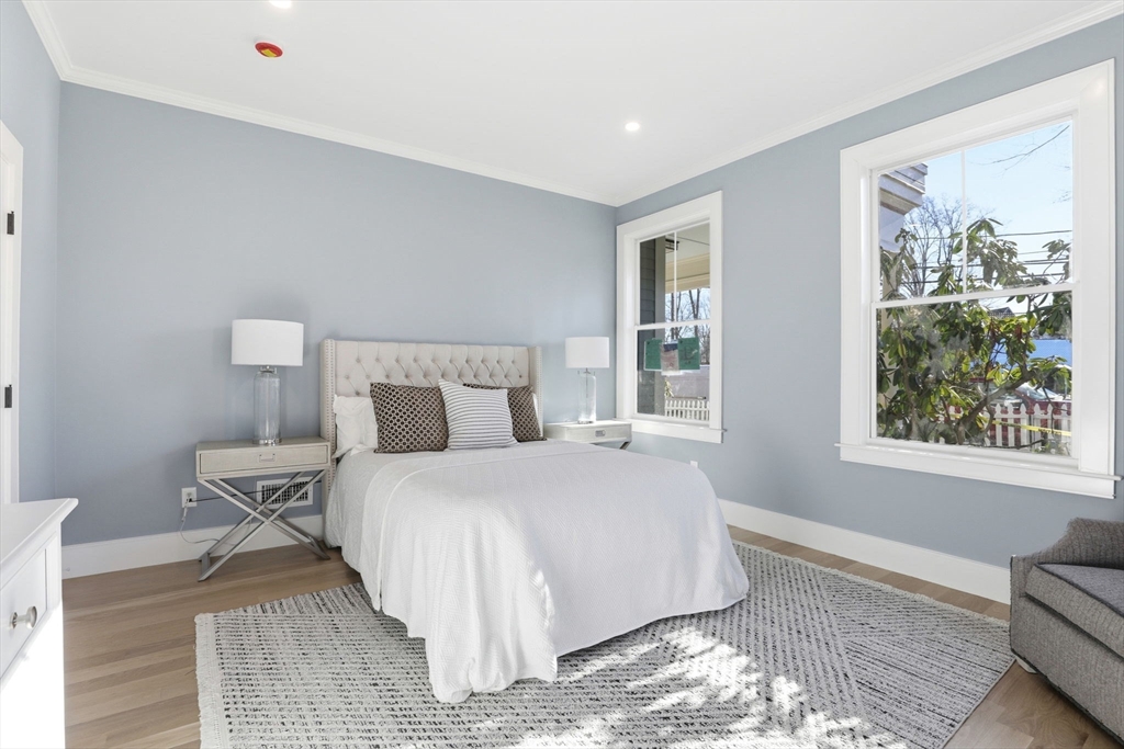 90 Addington Road, Unit 1 Brookline, MA 02445 - Photo 12 of 24 a bedroom with a bed and wooden floor