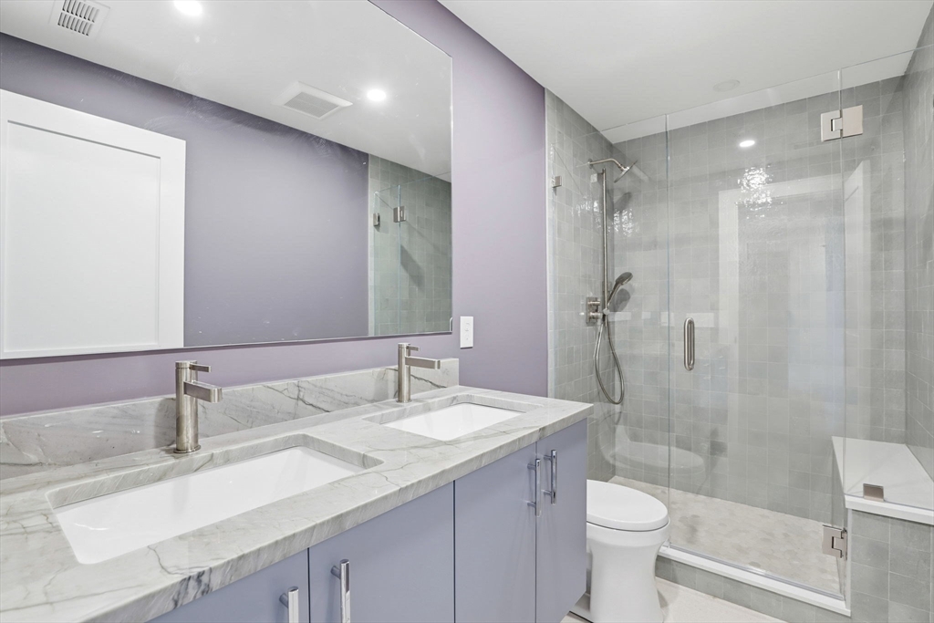90 Addington Road, Unit 1 Brookline, MA 02445 - Photo 17 of 24 a bathroom with a granite countertop sink toilet and shower