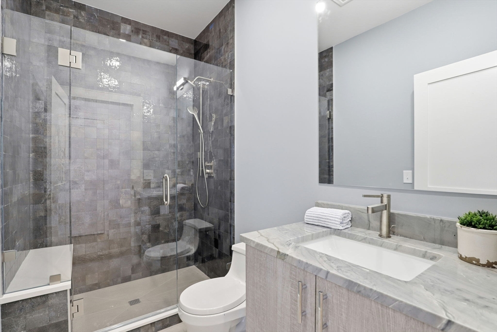 90 Addington Road, Unit 1 Brookline, MA 02445 - Photo 19 of 24 a bathroom with a sink a toilet and shower