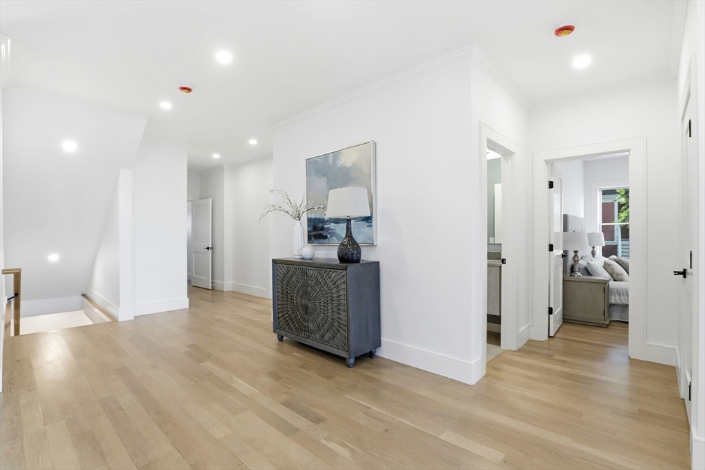 90 Addington Road, Unit 1 Brookline, MA 02445 - Photo 4 of 24 a view of a big room with wooden floor and windows