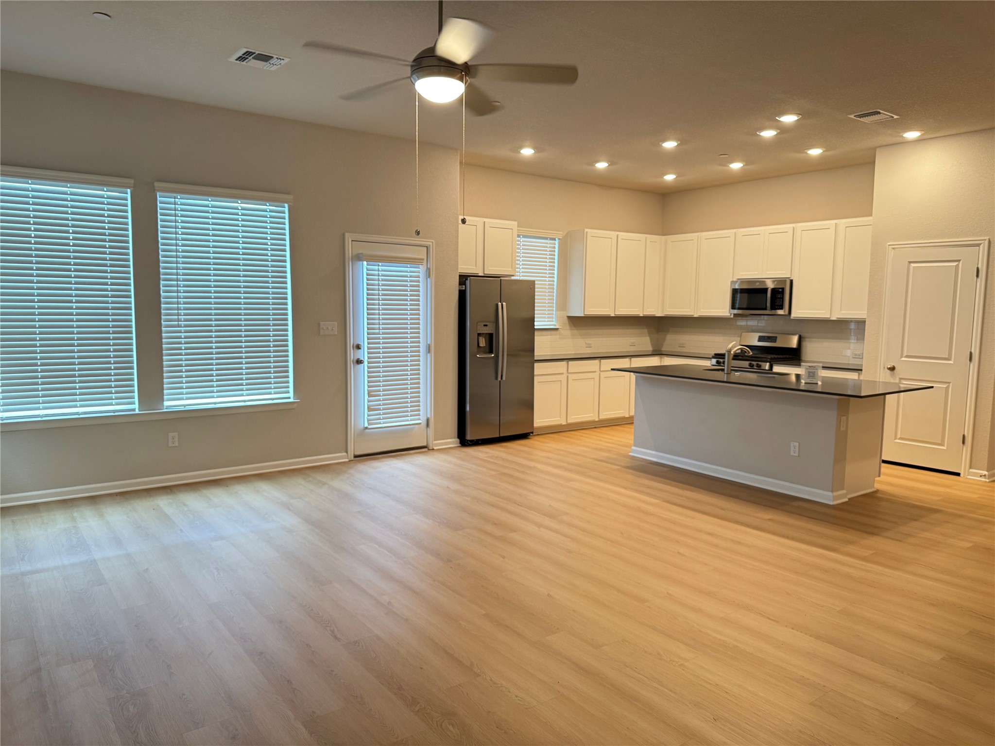 3000 Chisholm Trail Road, Unit 3 Round Rock, TX 78681 - Photo 6 of 28 a kitchen with stainless steel appliances granite countertop a refrigerator and a stove top oven