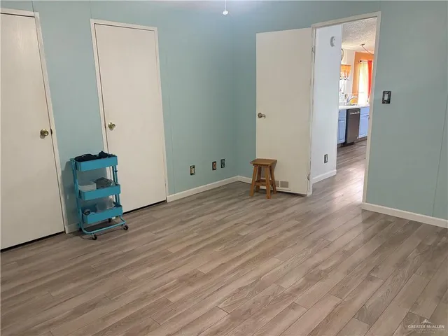 a view of room with window and wooden floor