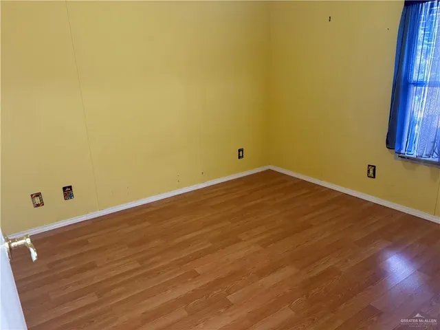 a bathroom with a glass door shower and a mirror