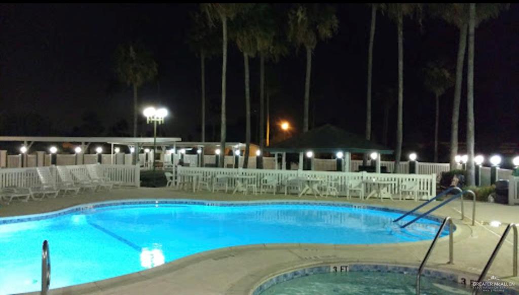 2515 Meadowlark Street Palmview, TX 78572 - Photo 24 of 26 Pool at night featuring a community pool and a community hot tub