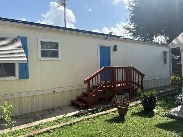 a view of a house with yard and sitting area