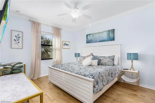 a bedroom with a bed and a lamp on dresser